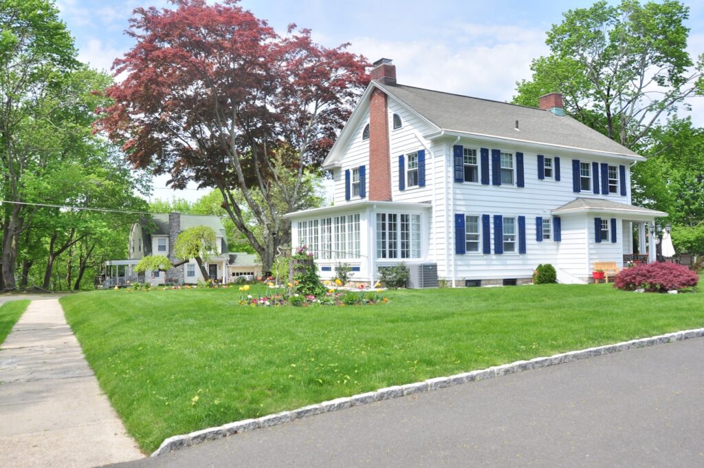 A single-family home with a lawn and trees