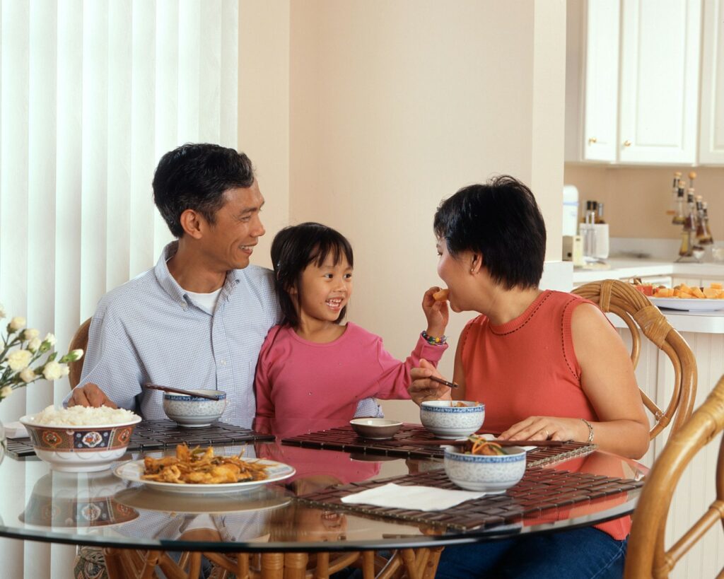 A family sharing a meal around the kitchen table