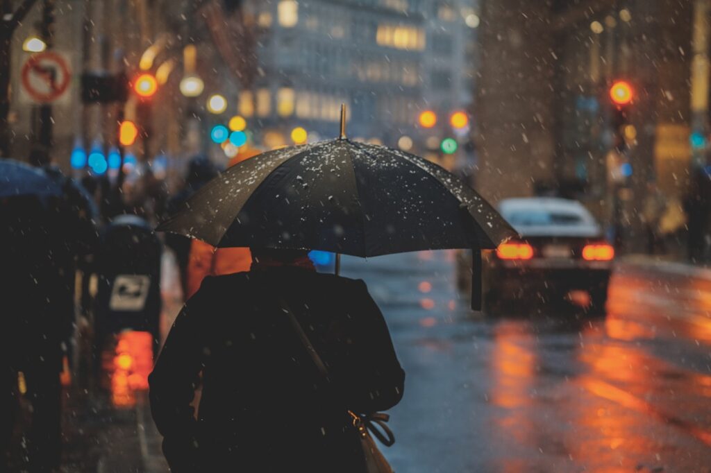 Person walking with an umbrella during heavy rain